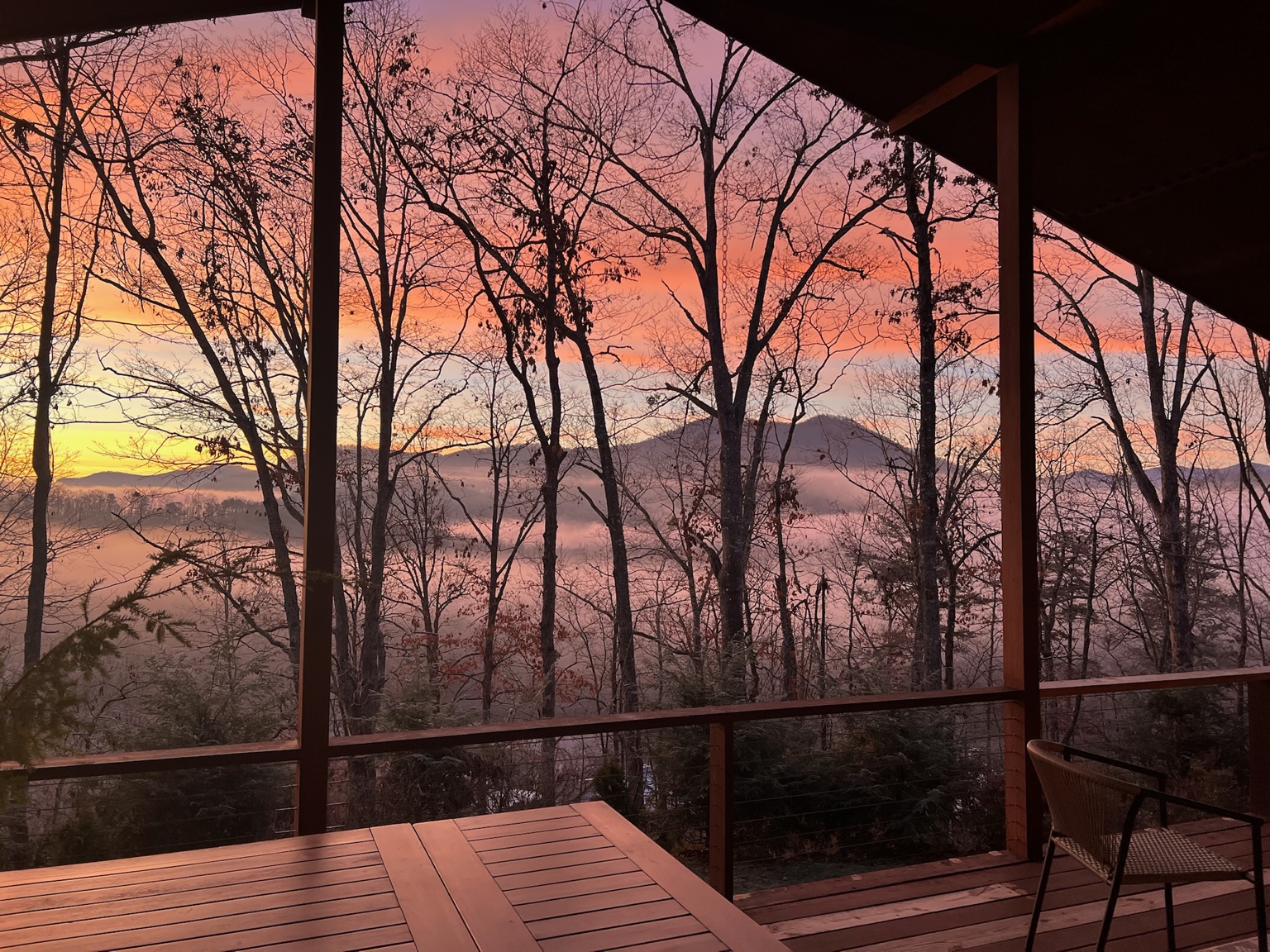 Pink and orange sunset over the mountains, seen from the porch